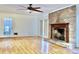 Living room features hardwood floors, fireplace, and ceiling fan at 4653 Flat Bridge Sw Rd, Stockbridge, GA 30281