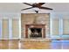 Living room with brick fireplace and hardwood floors and doors to outside at 4653 Flat Bridge Sw Rd, Stockbridge, GA 30281