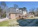 Back exterior view with a deck and attached two-car garage at 5545 Woodsong Trl, Dunwoody, GA 30338