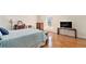 Bright bedroom featuring hardwood floors, large window, and tasteful furnishings at 5545 Woodsong Trl, Dunwoody, GA 30338