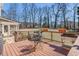 Outdoor deck featuring a dining table and chairs, perfect for enjoying the serene backyard views at 5545 Woodsong Trl, Dunwoody, GA 30338