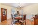 Charming dining room with hardwood floors, elegant furnishings and bright window views at 5545 Woodsong Trl, Dunwoody, GA 30338