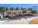 Charming brick home featuring red shutters, dormer windows, and a well-manicured front yard at 5545 Woodsong Trl, Dunwoody, GA 30338