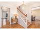 Foyer with hardwood floors, staircase, and a view of the formal dining room at 5545 Woodsong Trl, Dunwoody, GA 30338