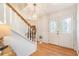Inviting entryway with hardwood floors, staircase, and elegant double doors featuring decorative glass at 5545 Woodsong Trl, Dunwoody, GA 30338