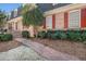 Inviting brick pathway leading to a well-maintained home with lush landscaping and manicured shrubs at 5545 Woodsong Trl, Dunwoody, GA 30338