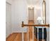 Upstairs hallway with a wood banister, hardwood floors and nice furnishings at 5545 Woodsong Trl, Dunwoody, GA 30338