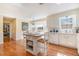 Sun-filled kitchen showcasing an island, white appliances, and an eat-in area with large windows at 5545 Woodsong Trl, Dunwoody, GA 30338