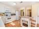 Well-lit kitchen featuring white cabinets, an island, and essential appliances at 5545 Woodsong Trl, Dunwoody, GA 30338
