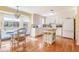 Bright kitchen featuring white cabinets, center island, and adjacent dining area at 5545 Woodsong Trl, Dunwoody, GA 30338