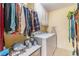 Organized laundry room with a washer, dryer, and storage shelves at 5545 Woodsong Trl, Dunwoody, GA 30338