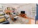 Cozy living room featuring a brick fireplace, built-in shelves, and comfortable seating area at 5545 Woodsong Trl, Dunwoody, GA 30338