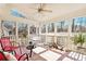 Bright and airy sunroom with tiled floors, offering a relaxing space with views of the backyard at 5545 Woodsong Trl, Dunwoody, GA 30338