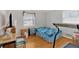 Bedroom with a twin bed, hardwood floors, and home office area at 2401 Prestige Valley Ct, Morrow, GA 30260