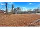 Wide shot of house and yard with autumn leaves at 2401 Prestige Valley Ct, Morrow, GA 30260