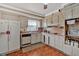 Galley kitchen with white cabinets and wood flooring at 2401 Prestige Valley Ct, Morrow, GA 30260