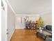Living room with hardwood floors, leather furniture, and decorative plants at 2401 Prestige Valley Ct, Morrow, GA 30260