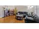 Living room with hardwood floors, leather couches, and coffee table at 2401 Prestige Valley Ct, Morrow, GA 30260