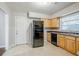 Kitchen with wooden cabinets, modern appliances, and tile flooring at 2937 Cascade Sw Rd, Atlanta, GA 30311