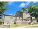 View of the back of the house with a large wooden deck and wood and metal railings at 4656 Bryant Rd, Snellville, GA 30039