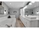 Bathroom featuring a large soaking tub, a double sink vanity and tile floors at 4656 Bryant Rd, Snellville, GA 30039