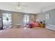 Spacious bedroom features carpet floors, large windows, ceiling fans, and soft pastel decor at 4656 Bryant Rd, Snellville, GA 30039