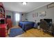 Bedroom with hardwood flooring, neutral walls, a blue accent rug, and a dark blue comforter at 4656 Bryant Rd, Snellville, GA 30039