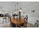Elegant dining area with a classic table set, pendant lighting, and views into the modern kitchen at 4656 Bryant Rd, Snellville, GA 30039