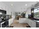 Open-concept kitchen featuring granite countertops, stainless steel appliances, and an island with seating at 4656 Bryant Rd, Snellville, GA 30039