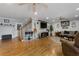 Spacious living room with hardwood floors, staircase, multiple ceiling fans, and comfortable seating at 4656 Bryant Rd, Snellville, GA 30039