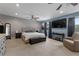Spacious main bedroom featuring neutral carpet, a tv, a ceiling fan, and windows with dark curtains at 4656 Bryant Rd, Snellville, GA 30039