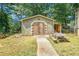 Exterior image of the backyard outbuilding that features double doors, siding, and a picnic table at 4656 Bryant Rd, Snellville, GA 30039
