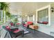 Relaxing front porch featuring wicker seating, striped rug, and charming decorative accents and hanging plants at 4656 Bryant Rd, Snellville, GA 30039