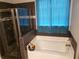 Bathroom with soaking tub, shower, and dark tile at 110 Sampson Ct, Covington, GA 30016