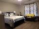 Main bedroom with a king-size bed and sitting area at 110 Sampson Ct, Covington, GA 30016