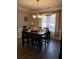 Formal dining room with large table, chandelier, and hardwood floors at 110 Sampson Ct, Covington, GA 30016