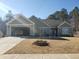 House exterior featuring a two-car garage and well-maintained lawn at 110 Sampson Ct, Covington, GA 30016