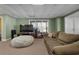 Finished basement with large sectional sofa and beanbag chair at 164 Castlewood Rd, Tyrone, GA 30290