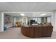 Finished basement with a large sectional sofa and entertainment center at 164 Castlewood Rd, Tyrone, GA 30290