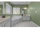 Spa-like bathroom with a corner tub and double vanities at 164 Castlewood Rd, Tyrone, GA 30290