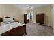 Small bedroom with a double bed and vintage wooden wardrobe at 164 Castlewood Rd, Tyrone, GA 30290