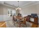Formal dining room with wooden table and chandelier at 164 Castlewood Rd, Tyrone, GA 30290