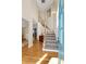 Hardwood floor entryway with staircase and teal door at 164 Castlewood Rd, Tyrone, GA 30290