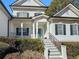 Two-story home with teal front door and a welcoming staircase at 164 Castlewood Rd, Tyrone, GA 30290
