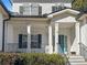 Front porch with teal door and black railings at 164 Castlewood Rd, Tyrone, GA 30290