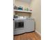 Convenient laundry room with washer, dryer, and overhead shelving at 164 Castlewood Rd, Tyrone, GA 30290