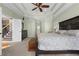 Bright main bedroom with a king-size bed and ensuite bathroom access at 164 Castlewood Rd, Tyrone, GA 30290