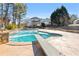 Inviting swimming pool with diving board, surrounded by a stone patio at 164 Castlewood Rd, Tyrone, GA 30290