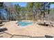 Inviting swimming pool with seating area and plenty of space for relaxing at 164 Castlewood Rd, Tyrone, GA 30290