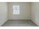 Well-lit bedroom with a window and neutral wall-to-wall carpet at 37 Delmoor Nw Ct, Atlanta, GA 30311